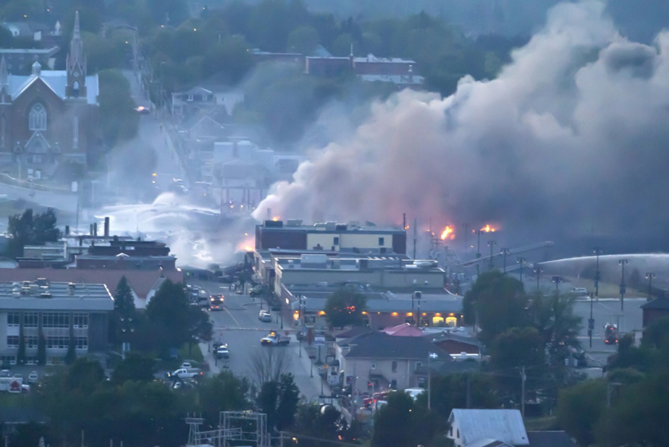 Firefighters douse blazes after a freight train loaded with oil derailed in Lac-Megantic in Canada's Quebec province.