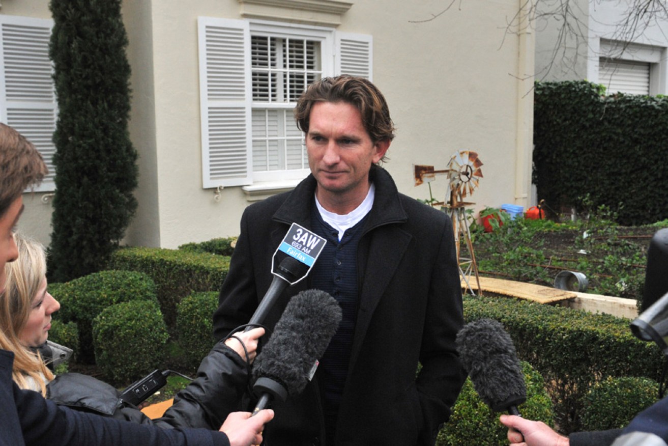 Hird talks to media outside his Toorak home