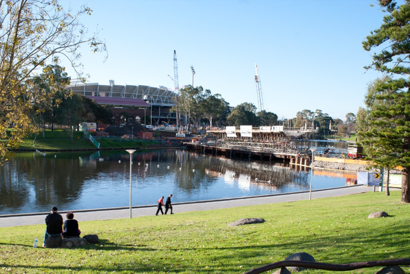 The view across the Torrens to Adelaide Oval, with the new footbridge construction in progress. Photo: Nat Rogers/InDaily 