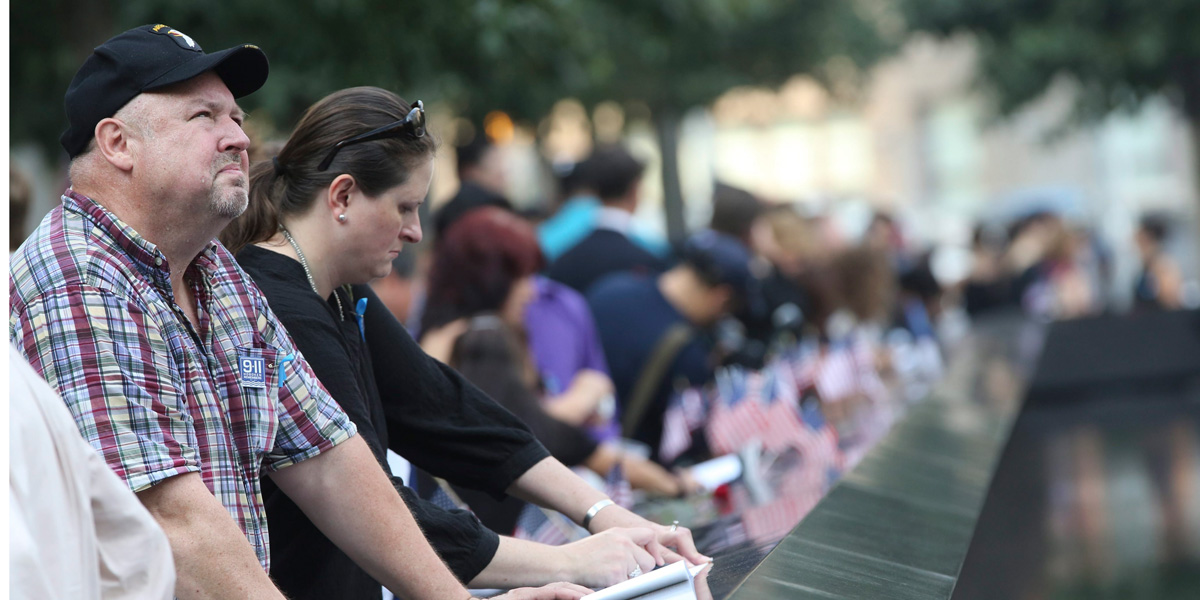 Mourners pause at the south reflection pool of the 9/11 Memorial during a ceremony marking the 12th anniversary of the 9/11 attacks on the World Trade Center in New York City.