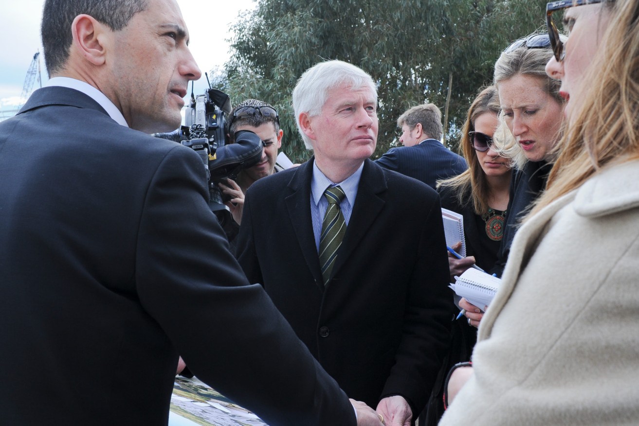 Planning Minister John Rau (centre) with ministerial colleague Tom Koutsantonis (left) and members of the media.