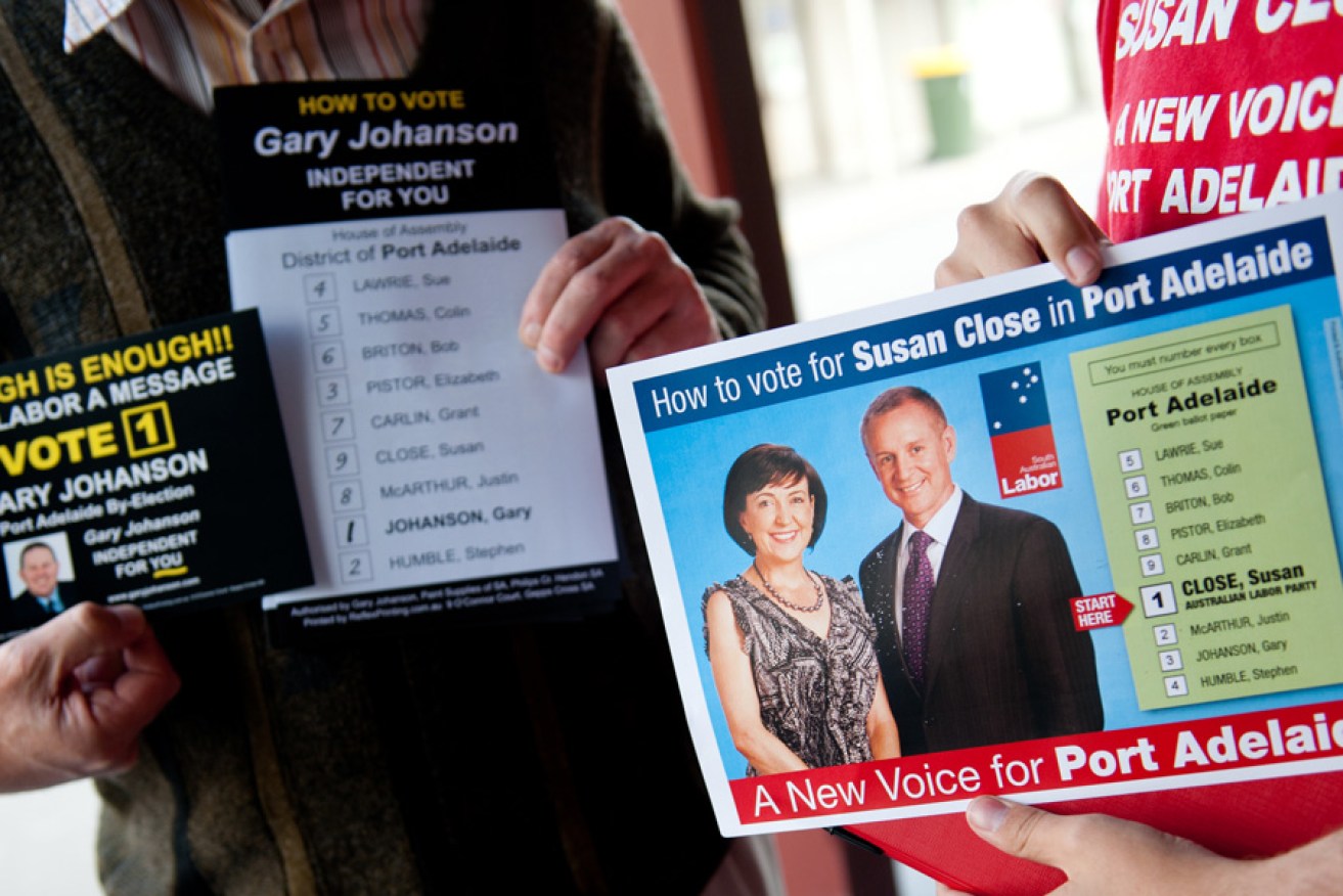 Volunteers with how-to-vote cards at the 2012 Port Adelaide by-election.