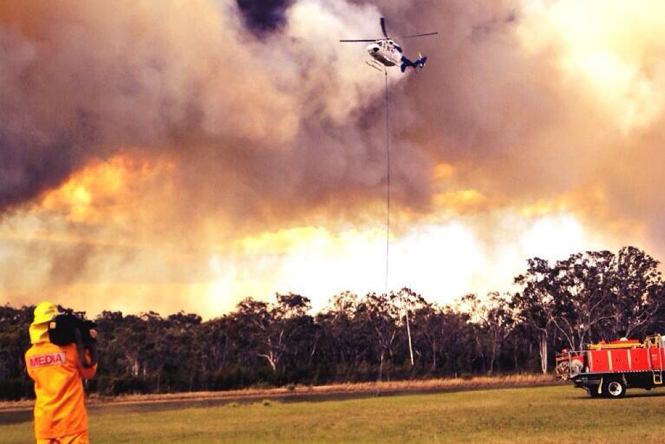 A helicopter attempting to extinguish a bushfire in Windsor, in Sydney's northwest, on Tuesday.