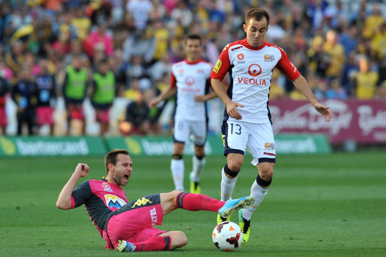 Mariners' Joshua Rose (left) tackled by United's Steven Lustica 