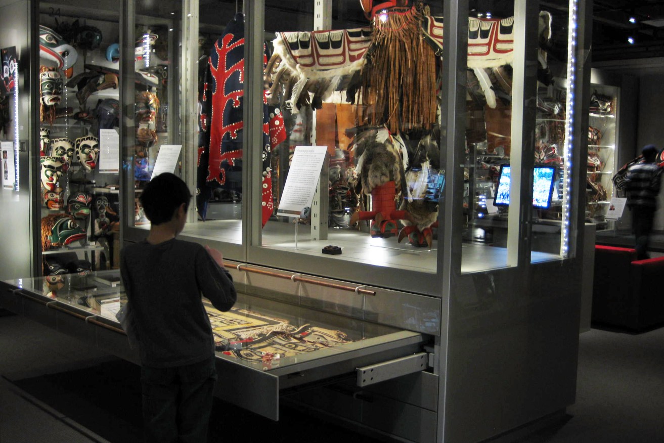 A child opening a drawer to view exhibits at the Multiversity Gallery, UBC Museum of Anthropology, in Vancouver, Canada.


