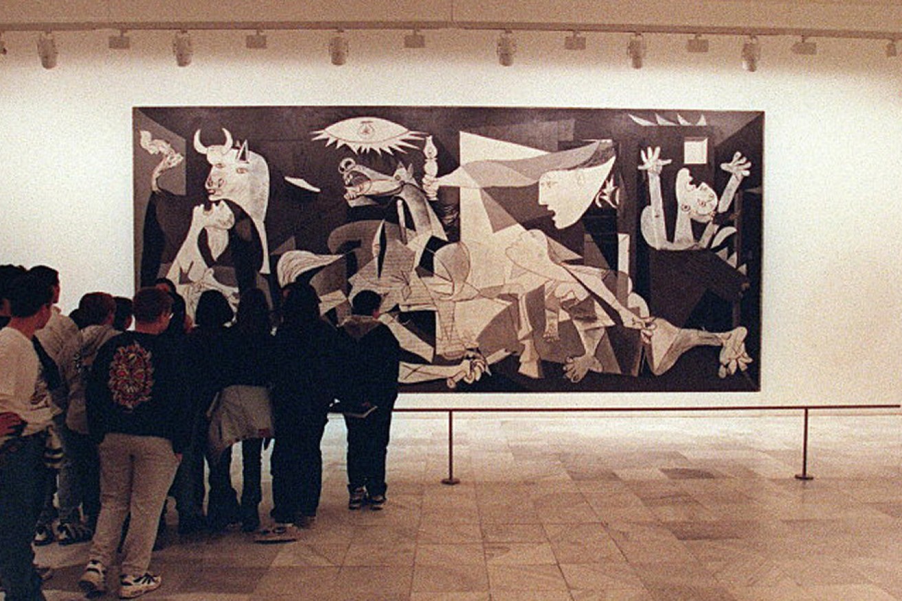 Crowds queue to see Pablo Picasso's Guernica.