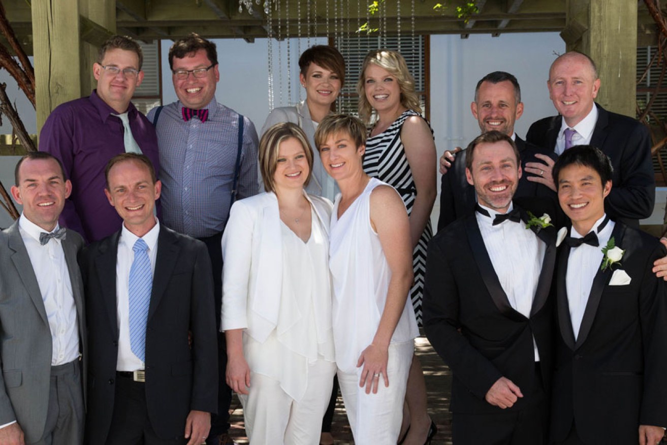 Newly married gay and lesbian couples pose for a photograph at Canberra's Old Parliament House last Saturday.