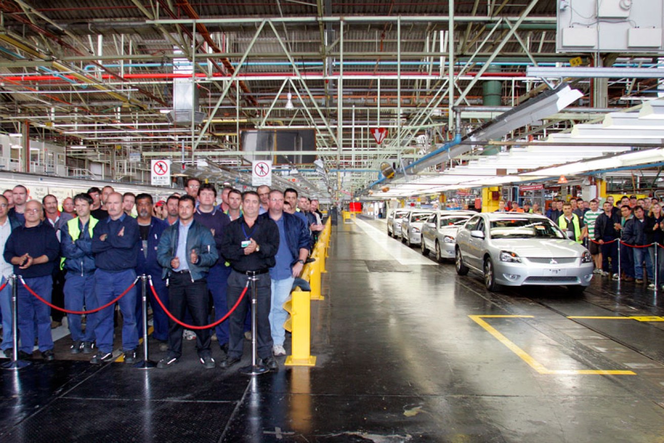 Mitsubishi workers with the last four cars to leave the factory's assembly line the day before the closure of the Tonsley Park factory in Adelaide in 2008.