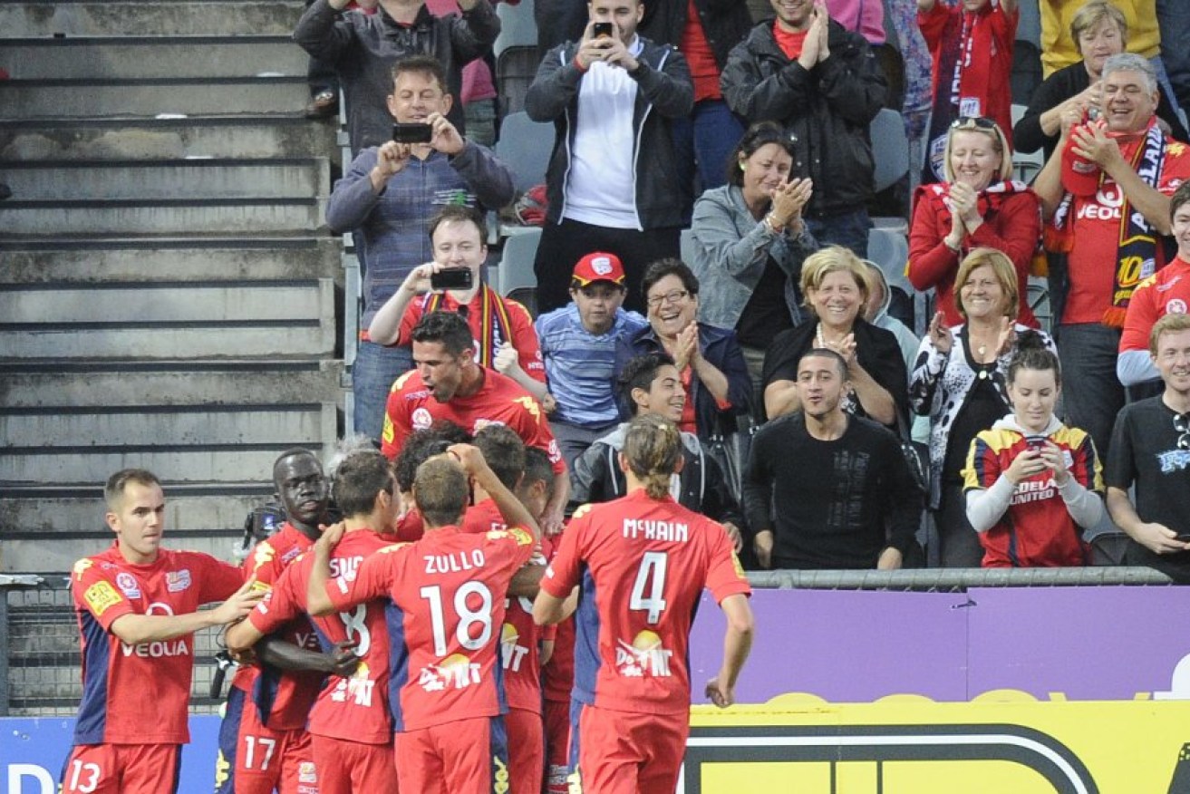 Adelaide United players celebrate a goal during last Friday's match against Sydney FC at Hindmarsh Stadium. Photo: AAP