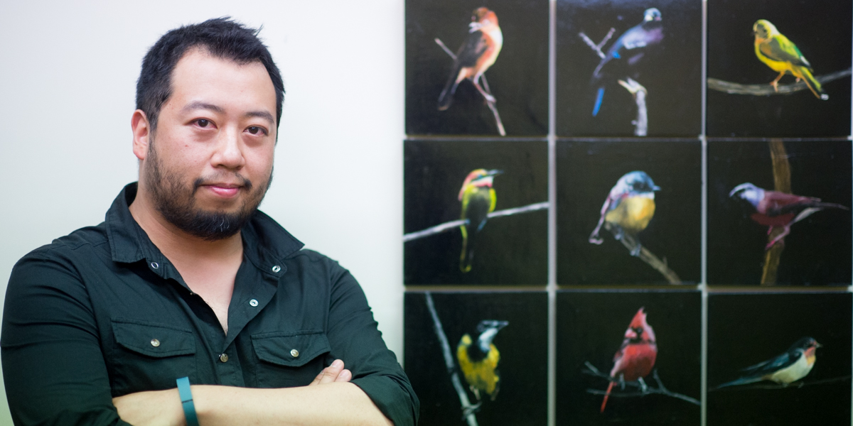 Datsun Tran with his oil painting Night Birds. Photo: Nat Rogers / InDaily