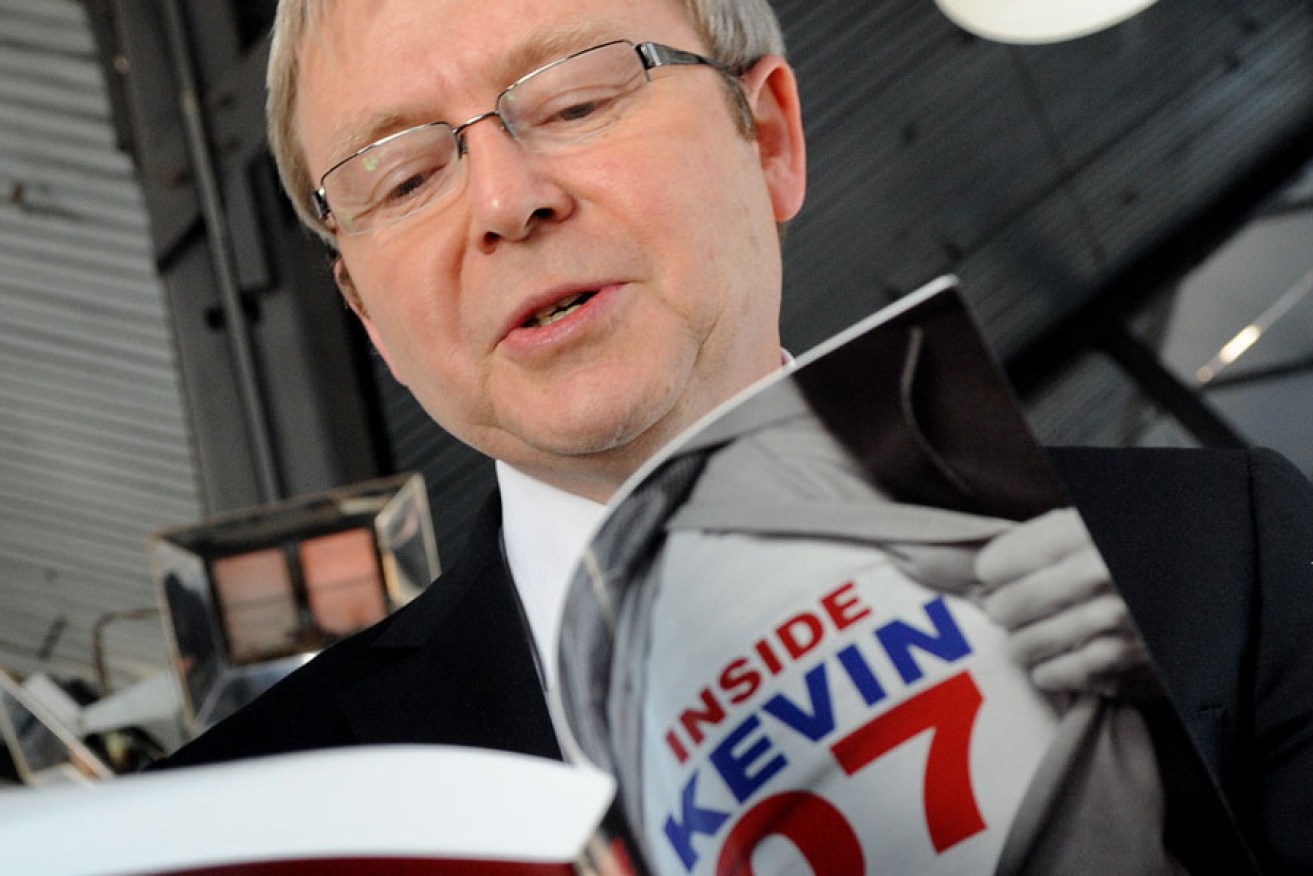 Then Prime Minister Kevin Rudd in 2008 with a journalist's book about his successful election campaign.