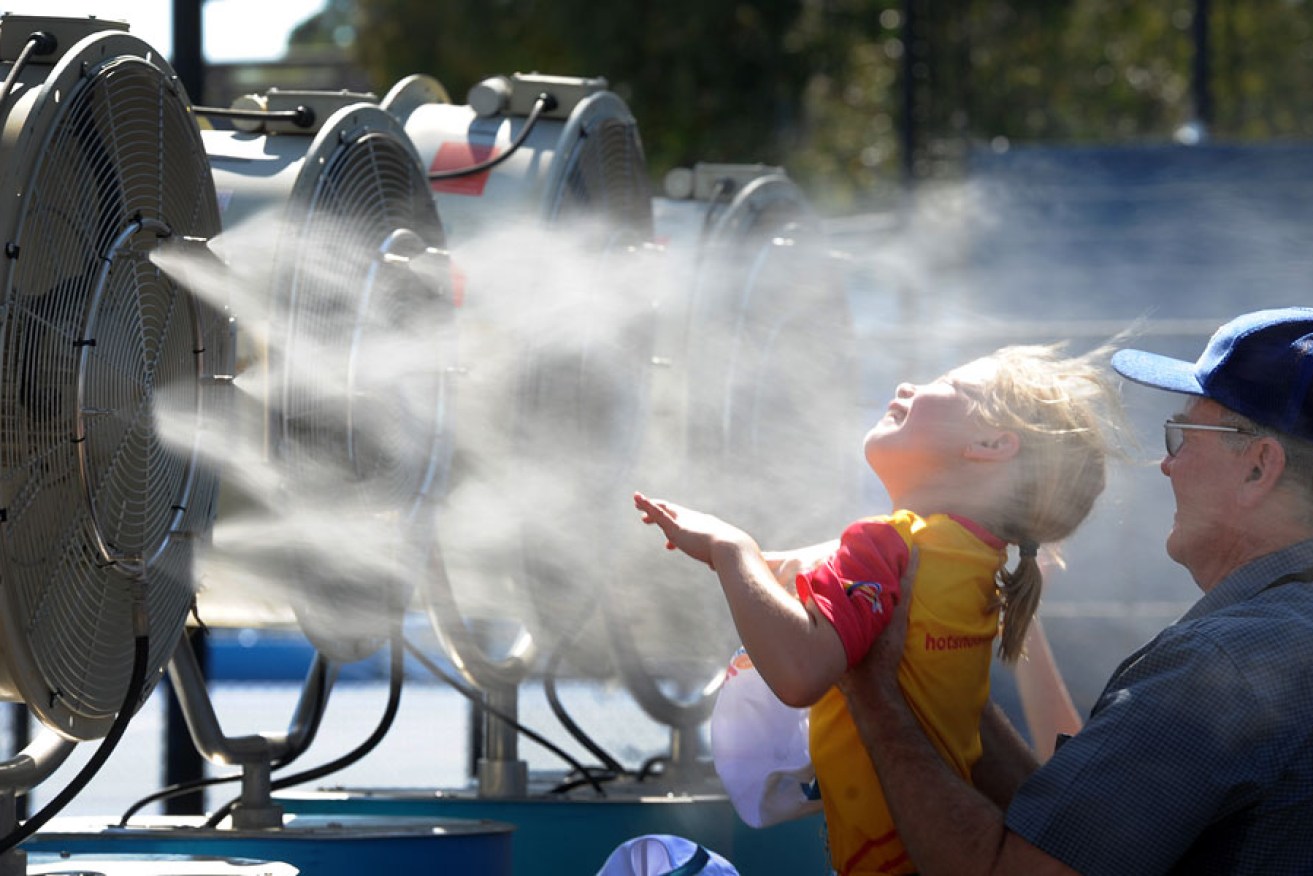 A young fan cools off during searing conditions at the Australian Open this week.