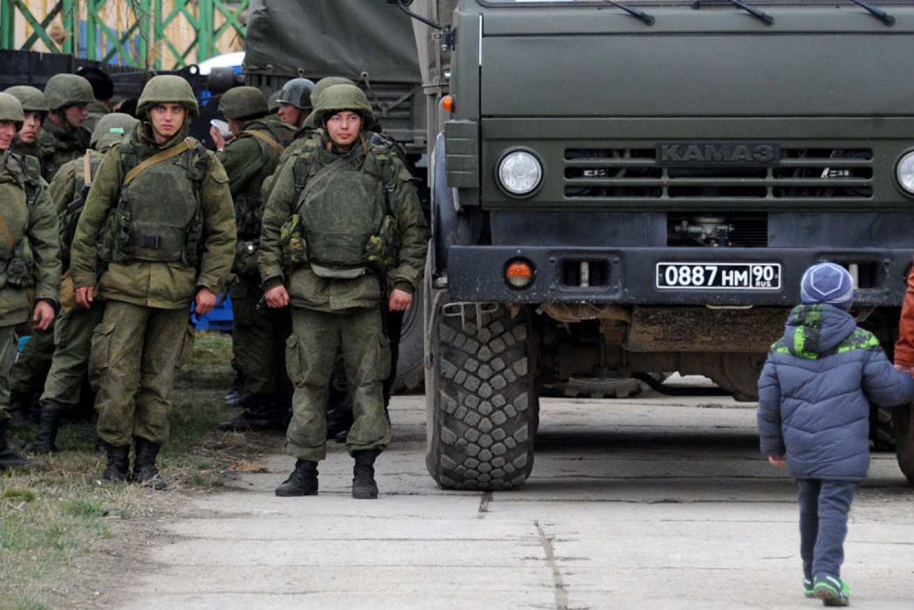 Military personnel stand near a Russian-made Kamaz truck in the eastern Crimea'a port city of Feodosiya on March 2.