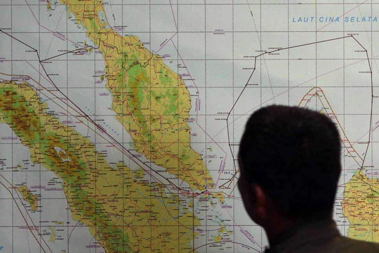 A member of the Indonesian Air Force inspects the Indonesian military search area for the missing Malaysian Airlines flight MH370 in 2014. Photo: AAP