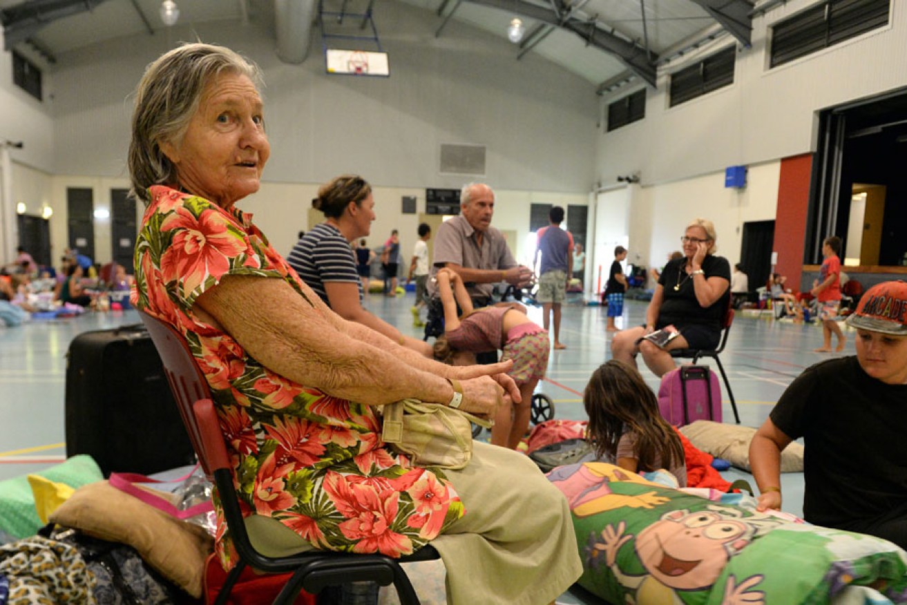 Eighty-six-year-old Win Bass and her family take shelter in the evacuation centre in Cooktown today.