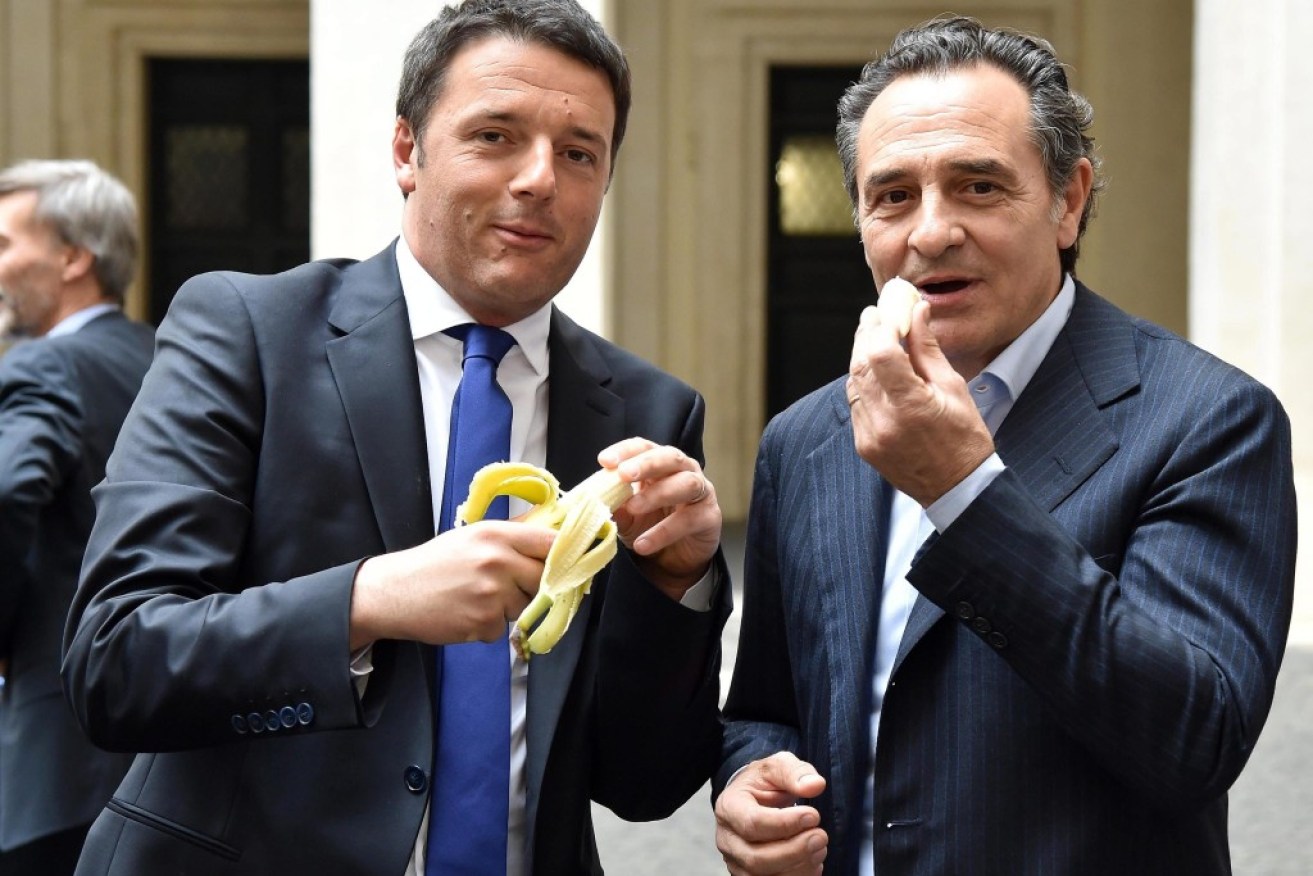 Italian Prime Minister Matteo Renzi (L) and Italy's national soccer coach Cesare Prandelli giving a symbolic demonstration of solidarity against racism in soccer.