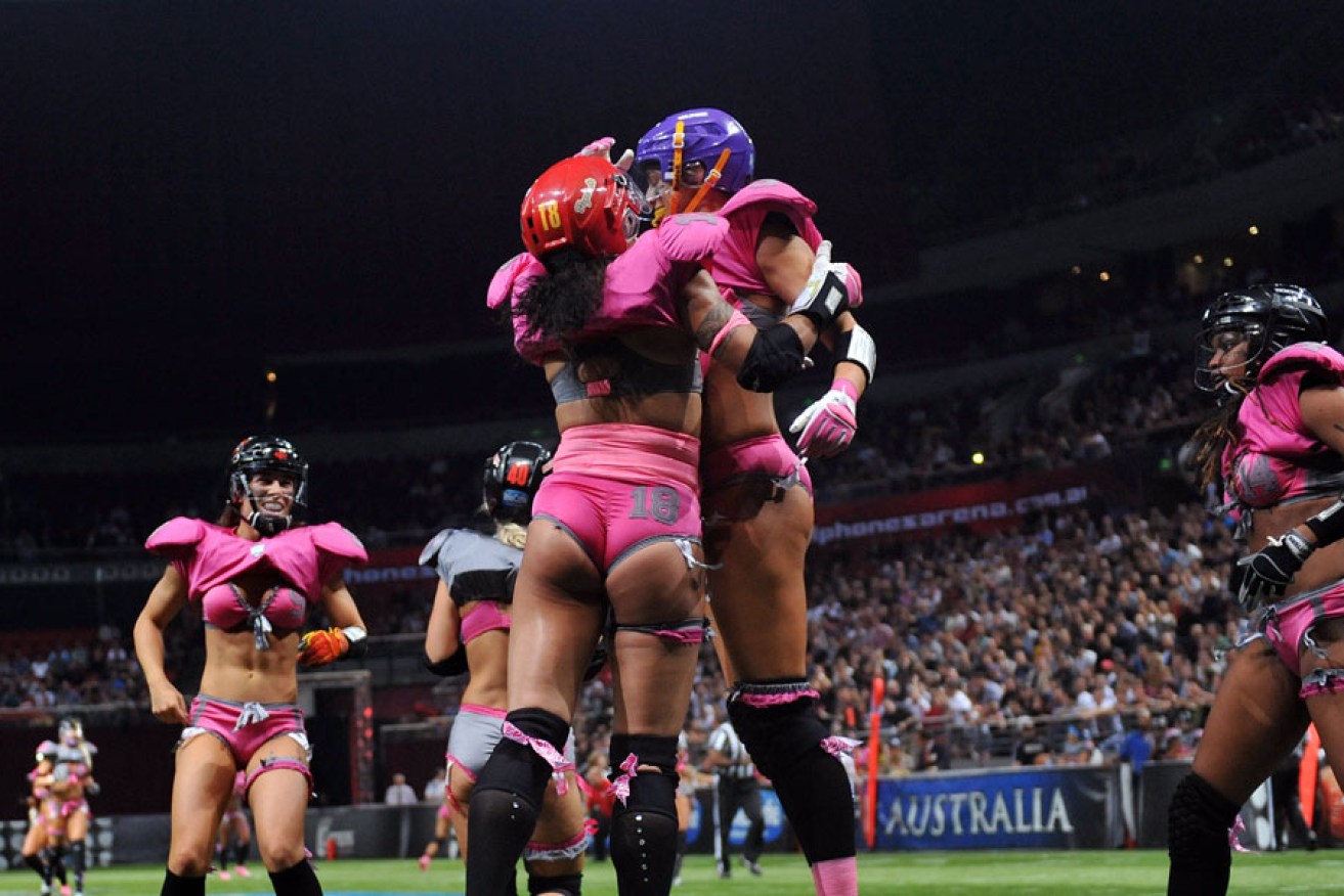 "Lingerie" football players celebrate a touchdown during a demonstration match in Sydney in 2012.