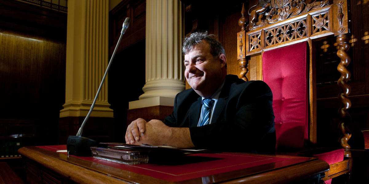 John Gazzola in happier days, siting in the president's chair. Photo: Nat Rogers/InDaily