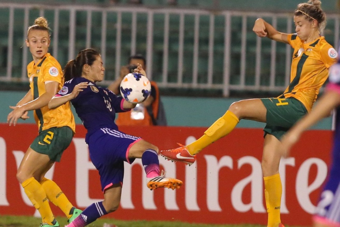 Japanese midfielder Sawa clashes with Australian defender Allen