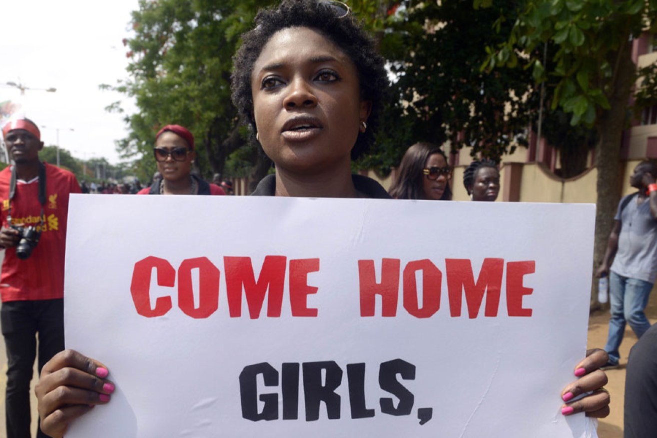 A woman carries placard to press for the release of missing Chibok school girls during a rally in Lagos yesterday. 