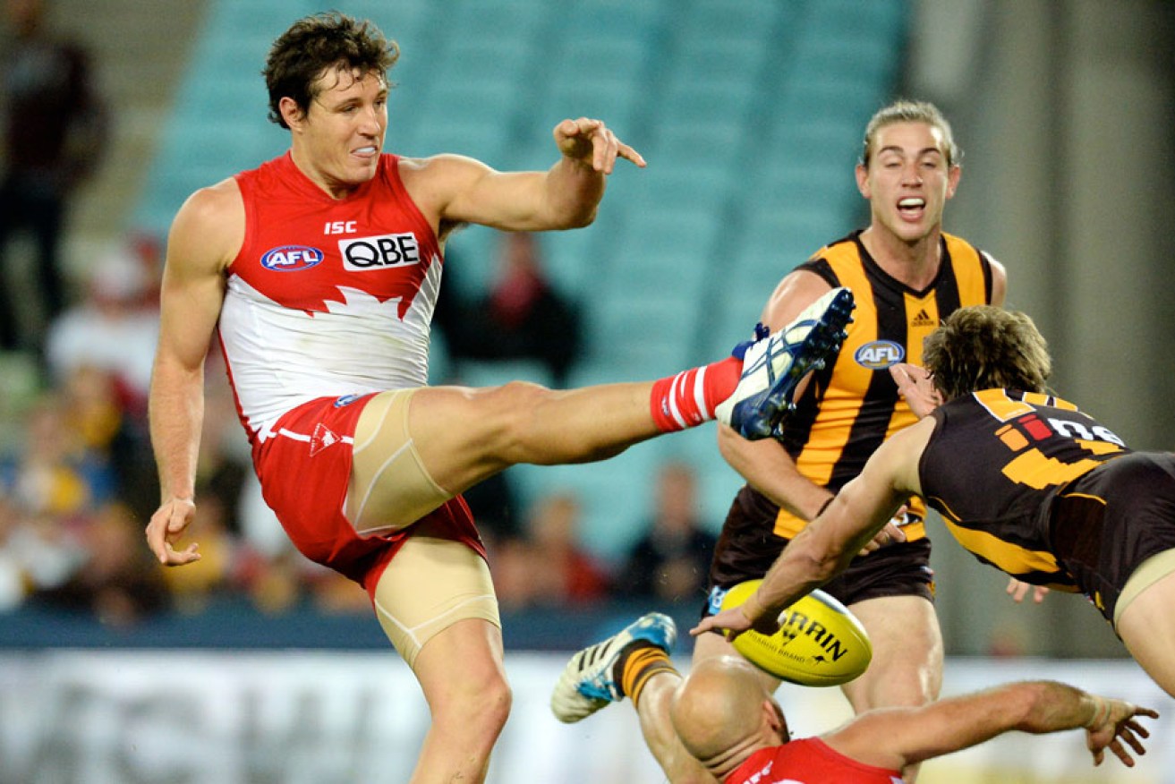 An unnamed, but vaguely familiar, Swans player fluffs a kick against the Hawks. 