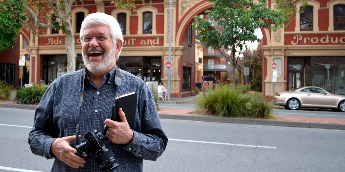 Keith Conlon in front of the Adelaide Fruit and Produce Market facade. Photo: Bension Siebert/InDaily