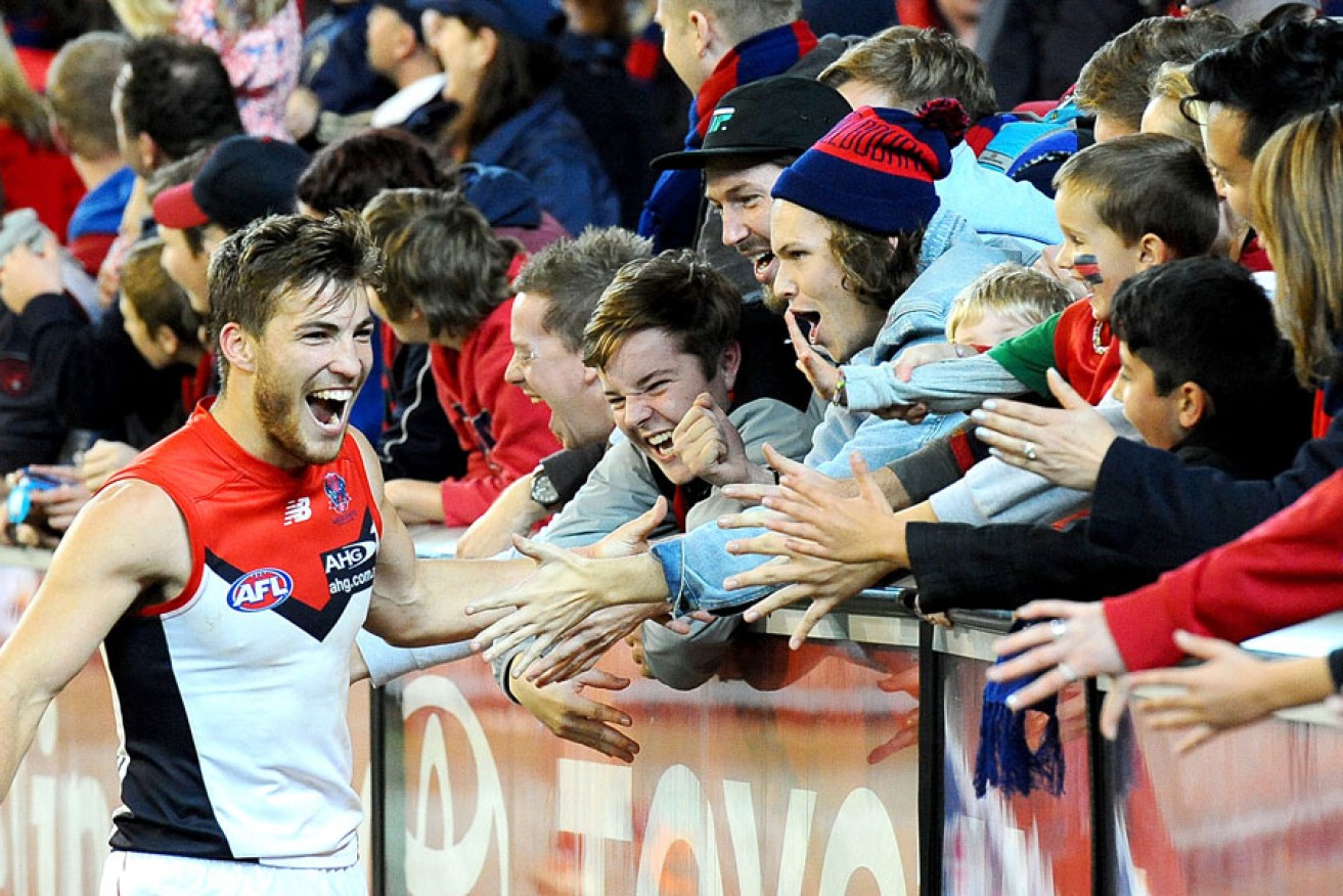 Young Melbourne midfielder Jack Viney celebrates with fans after the Demons' one-point win over Essendon.