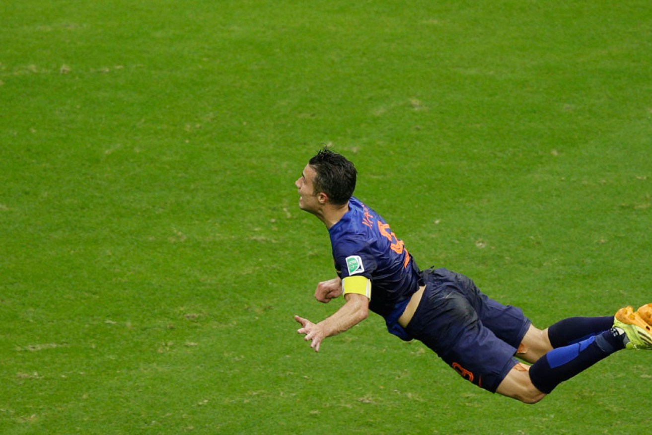 Robin van Persie in the midst of completing a headed goal against Spain.