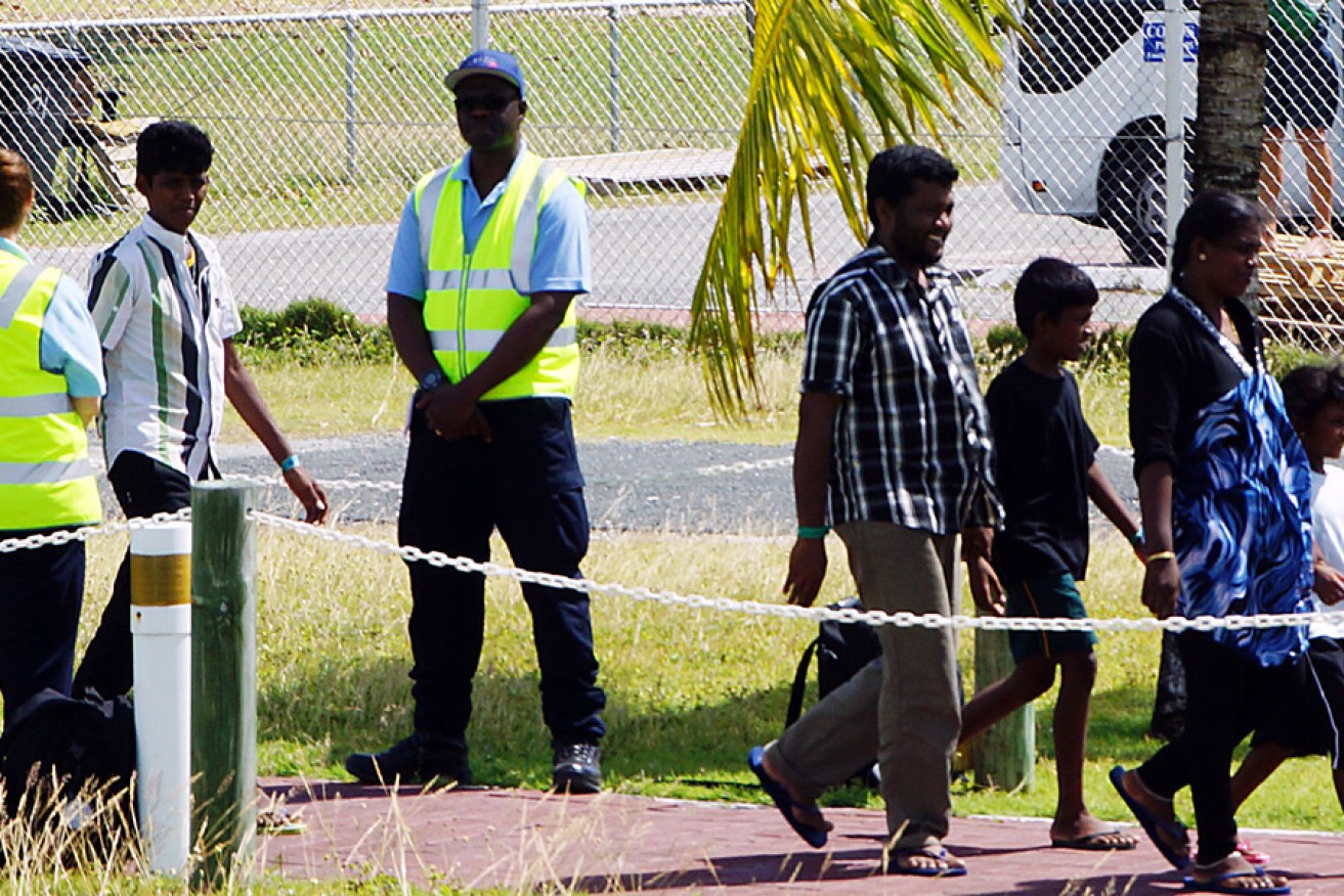  The asylum seekers arrive at Cocos Island yesterday. Photo: AAP