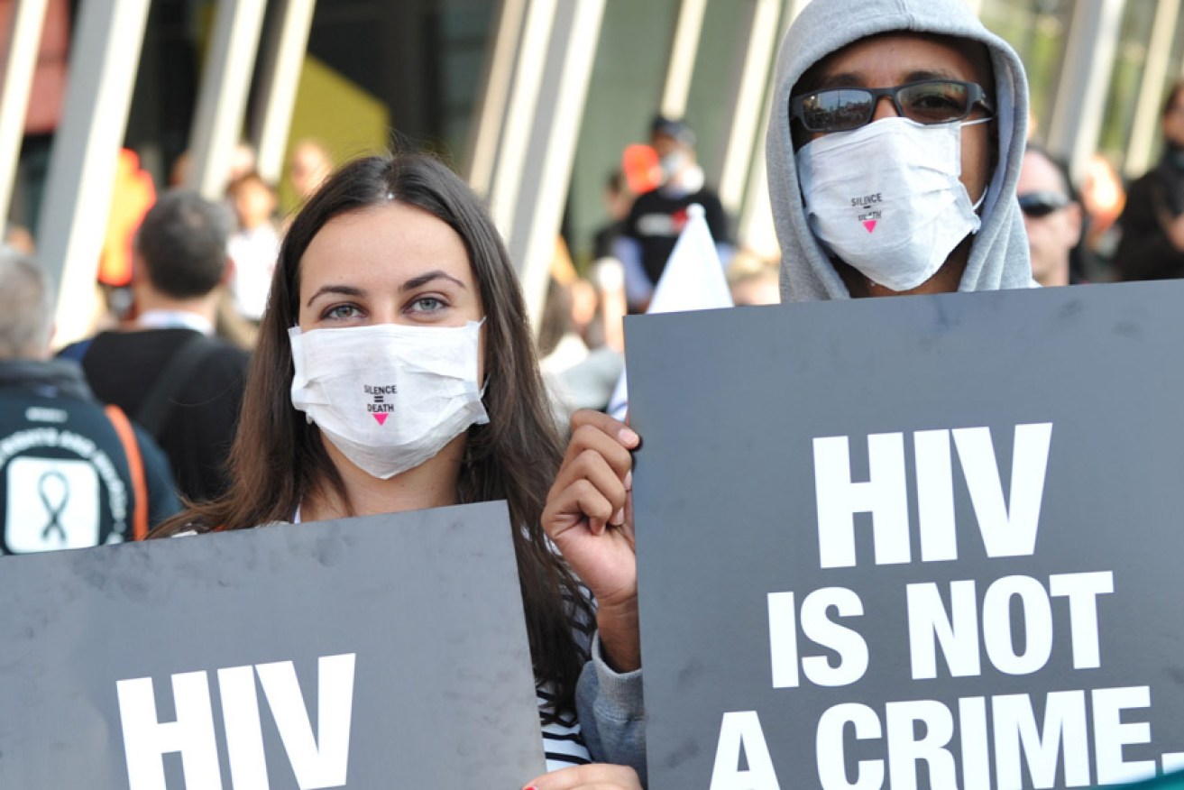 Activists display placards during a rally at the AIDS Conference in Melbourne. Photo: AFP