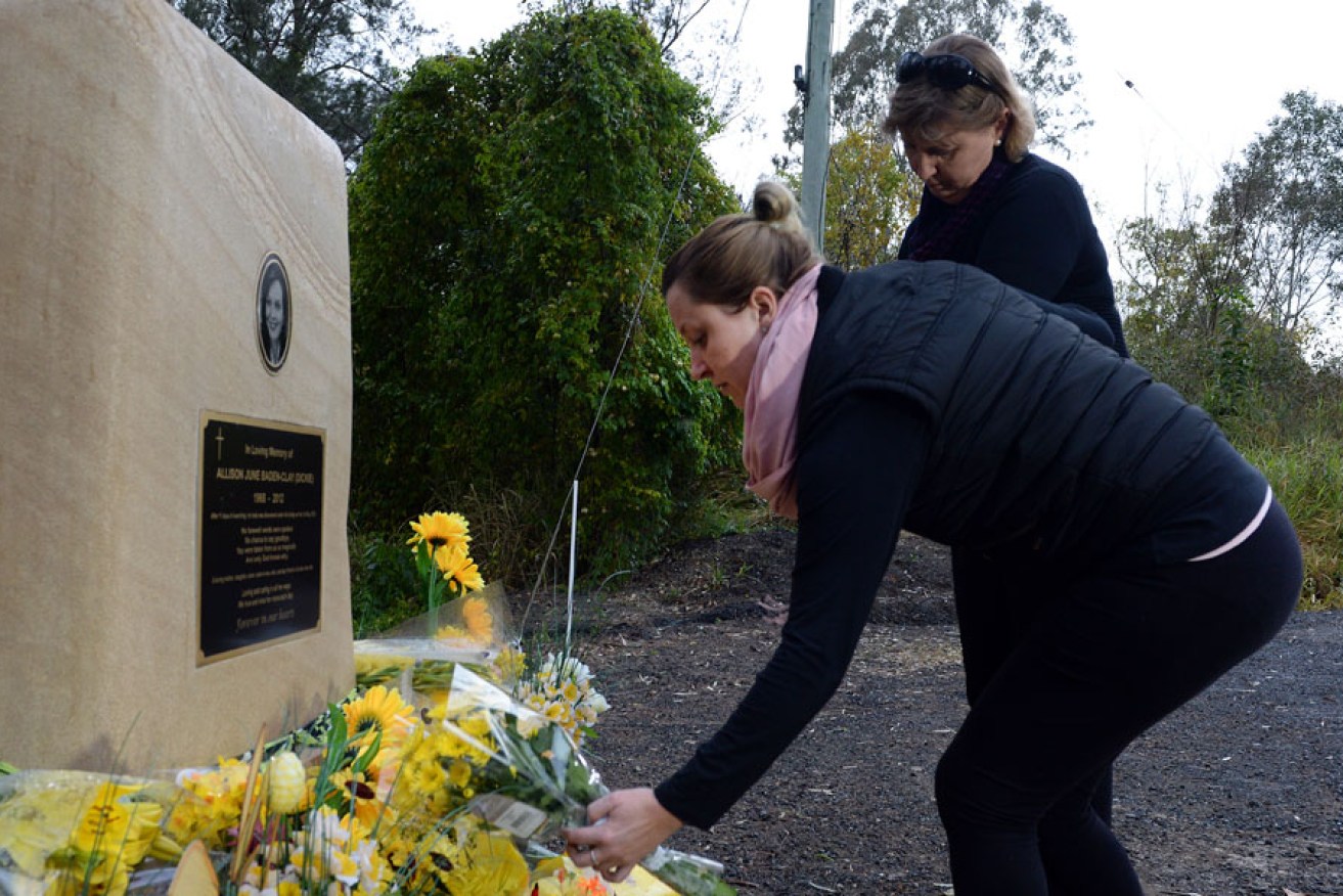 A file image of local residents laying flowers at the memorial for Allison Baden-Clay near the Kholo Creek location where her body was found. AAP photo