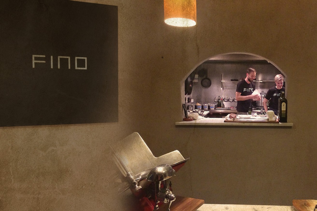 A mash-up of Fino's understated entrance sign, and the theatrical window into a very calm kitchen.