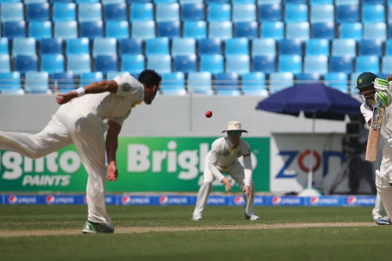 Younis Khan fends off a Johnson delivery