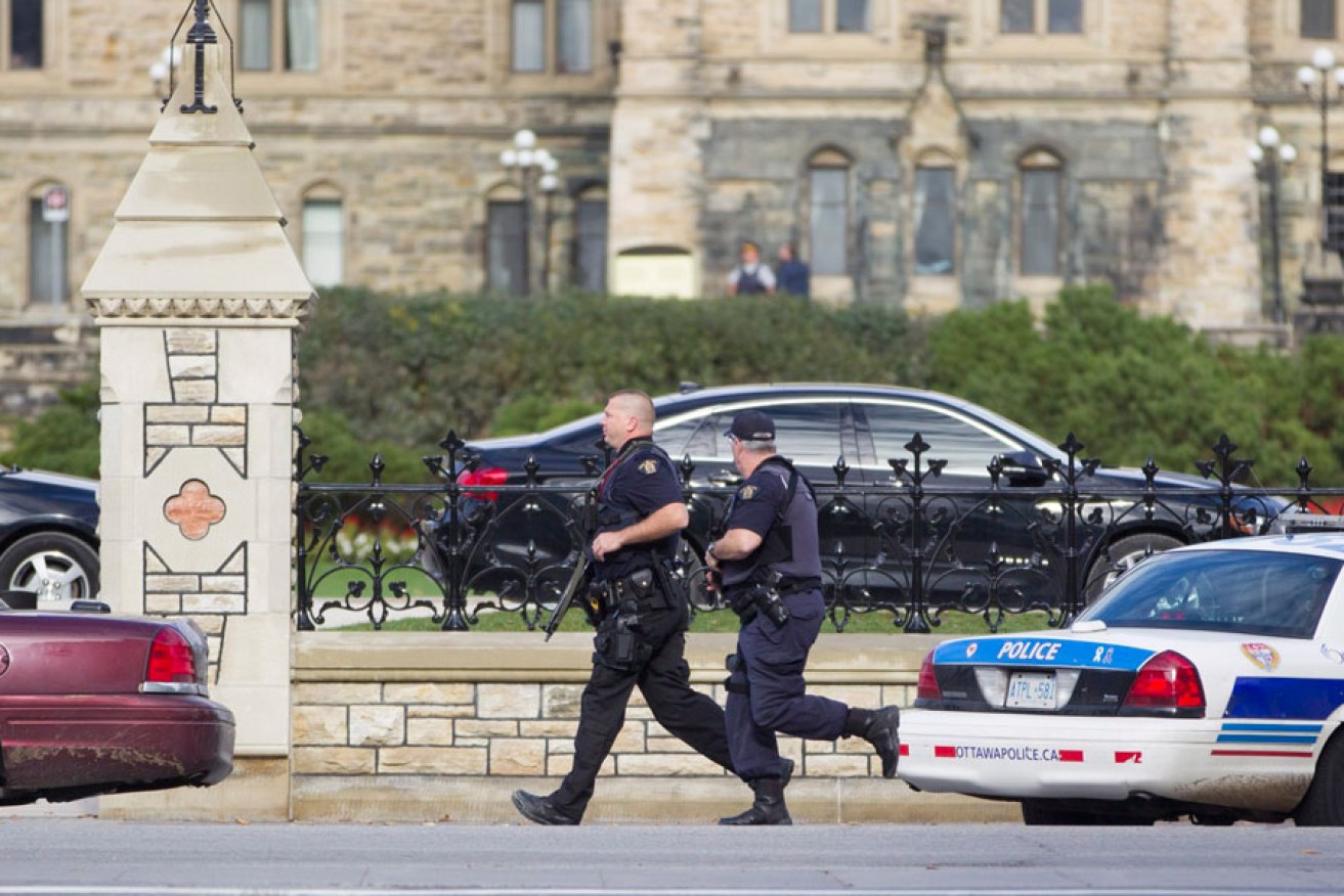 Emergency responders attempt to secure a portion of downtown Ottawa near Parliament Hill after the shooting.