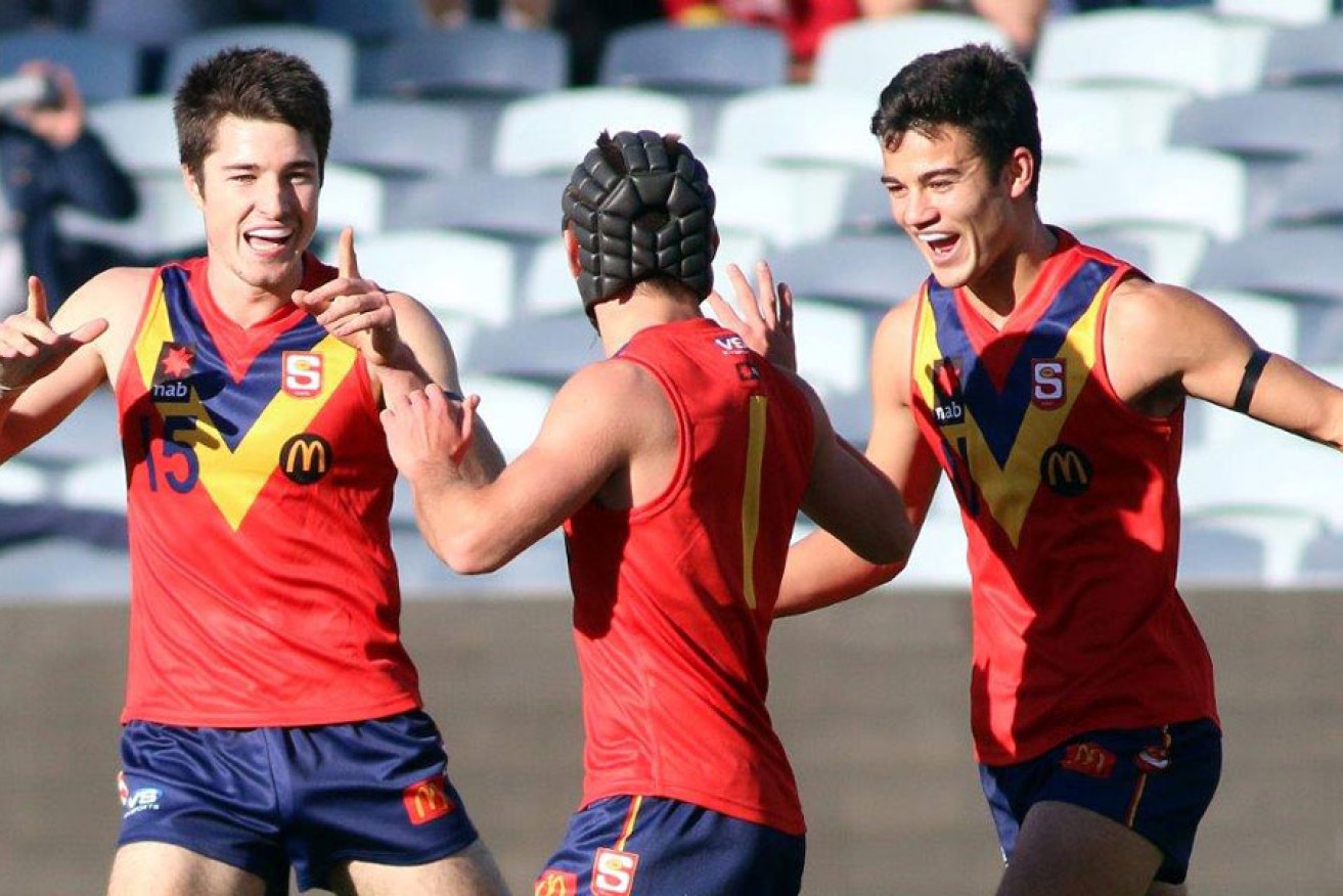Young guns: Alex Neal-Bullen (left), Caleb Daniel and Billy Stretch celebrate a goal during the Under 18s championships at Simonds Stadium. Photo: Peter Argent 