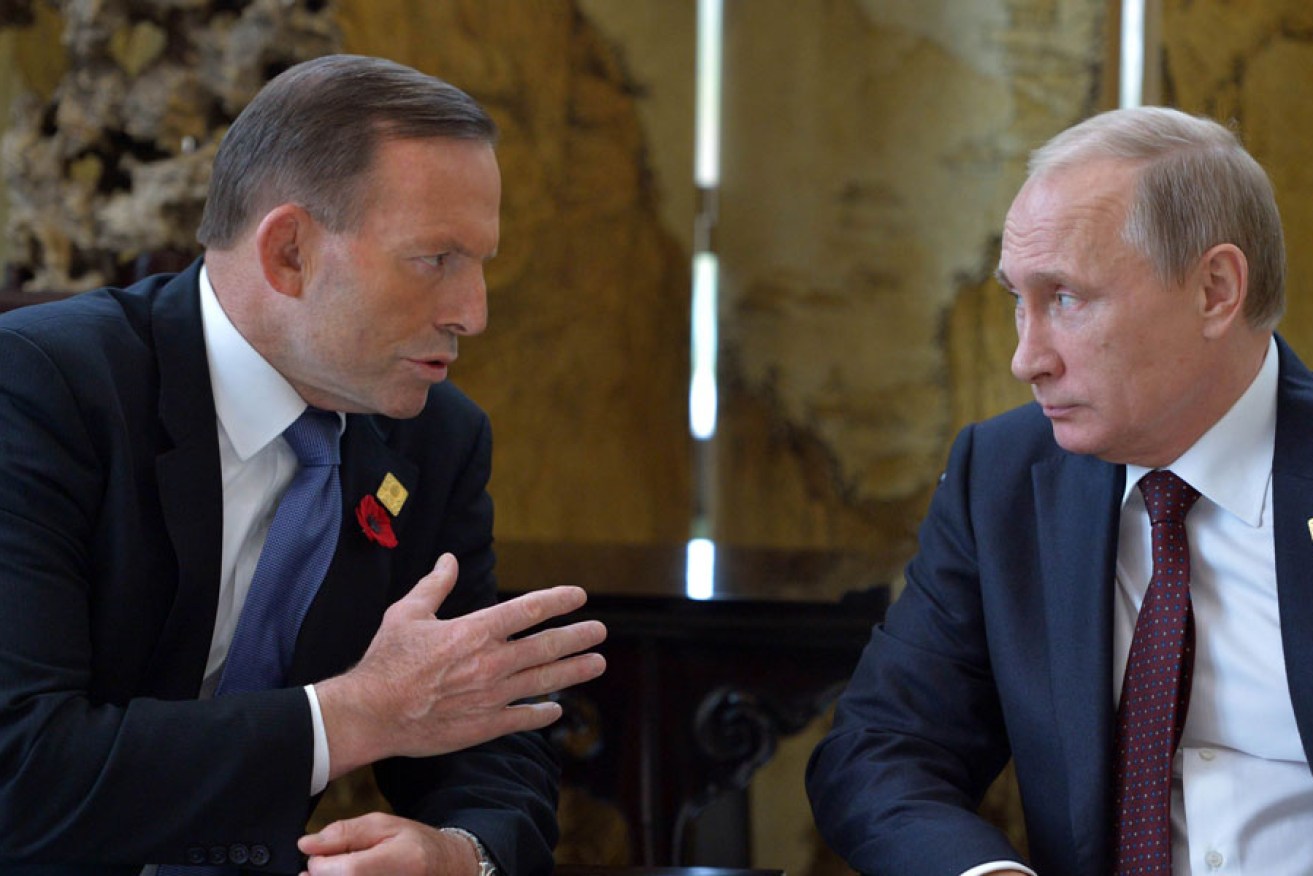 Russian President Vladimir Putin (R) speaks with Australia's Prime Minister Tony Abbott before the APEC summit in Beijing.