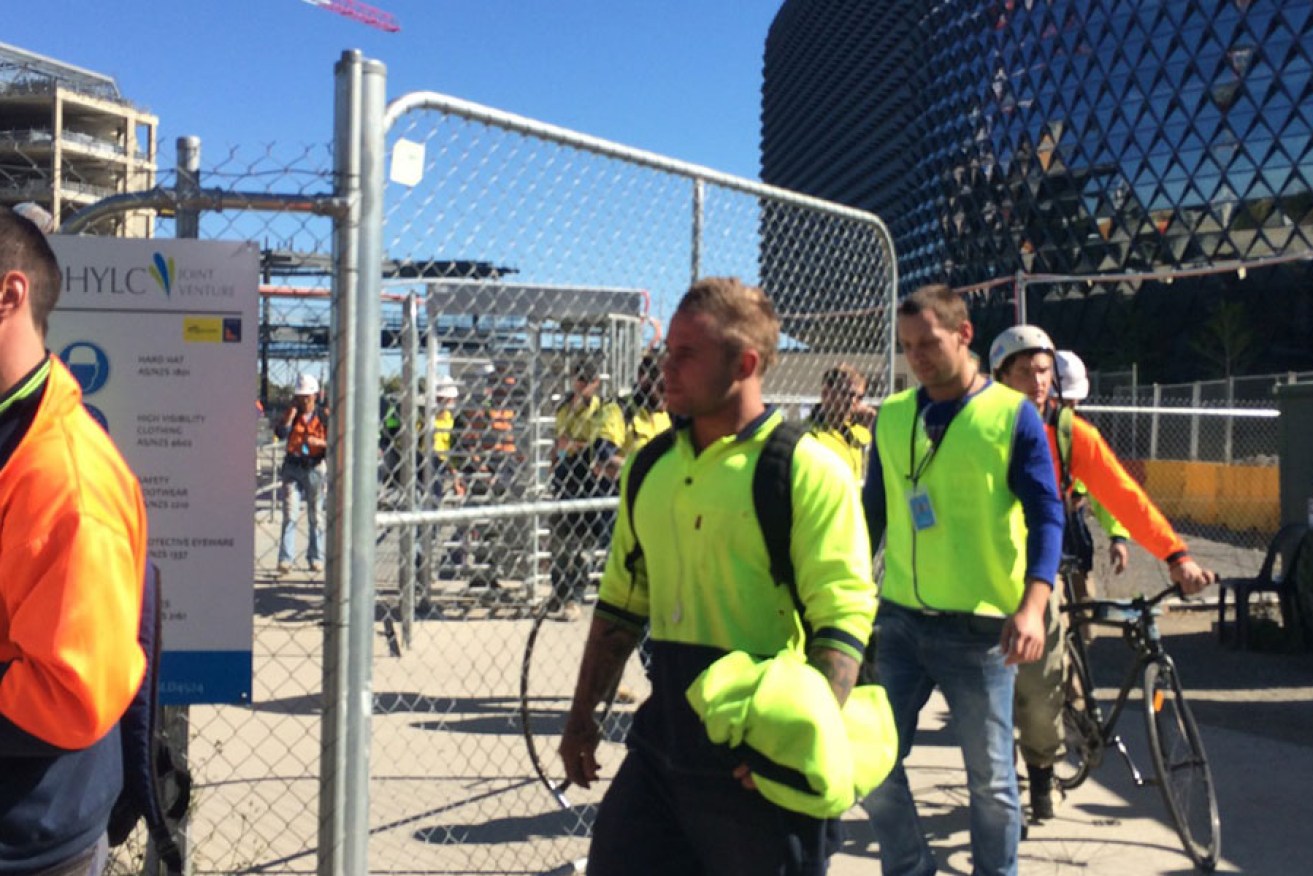 Workers leave the new RAH construction site today.