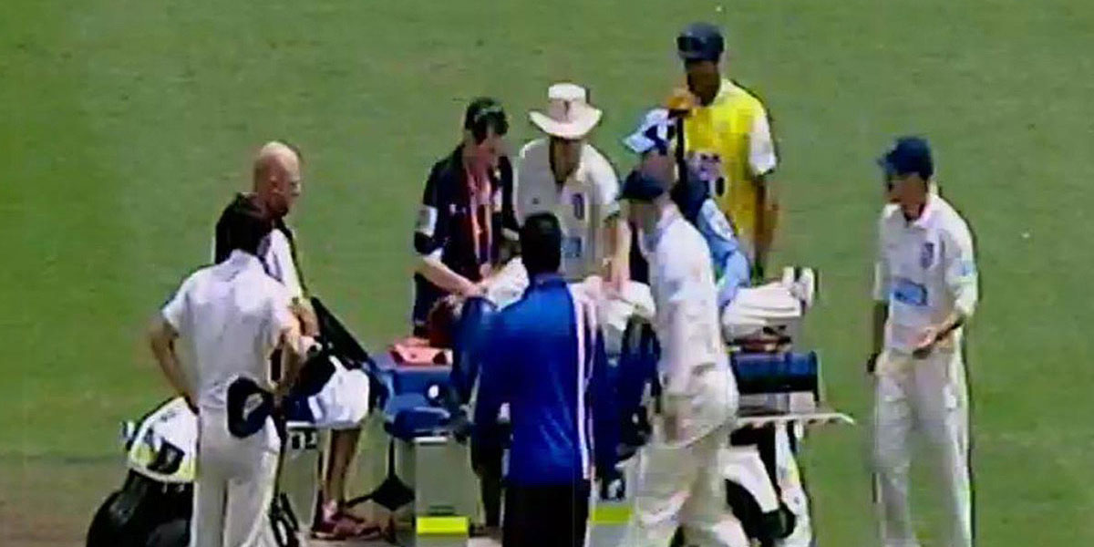 Phil Hughes receives treatment on-field at the SCG.