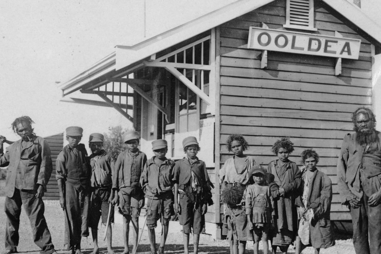 Aboriginal men and children outside the Ooldea post office, circa 1920. Photo: State Library of South Australia