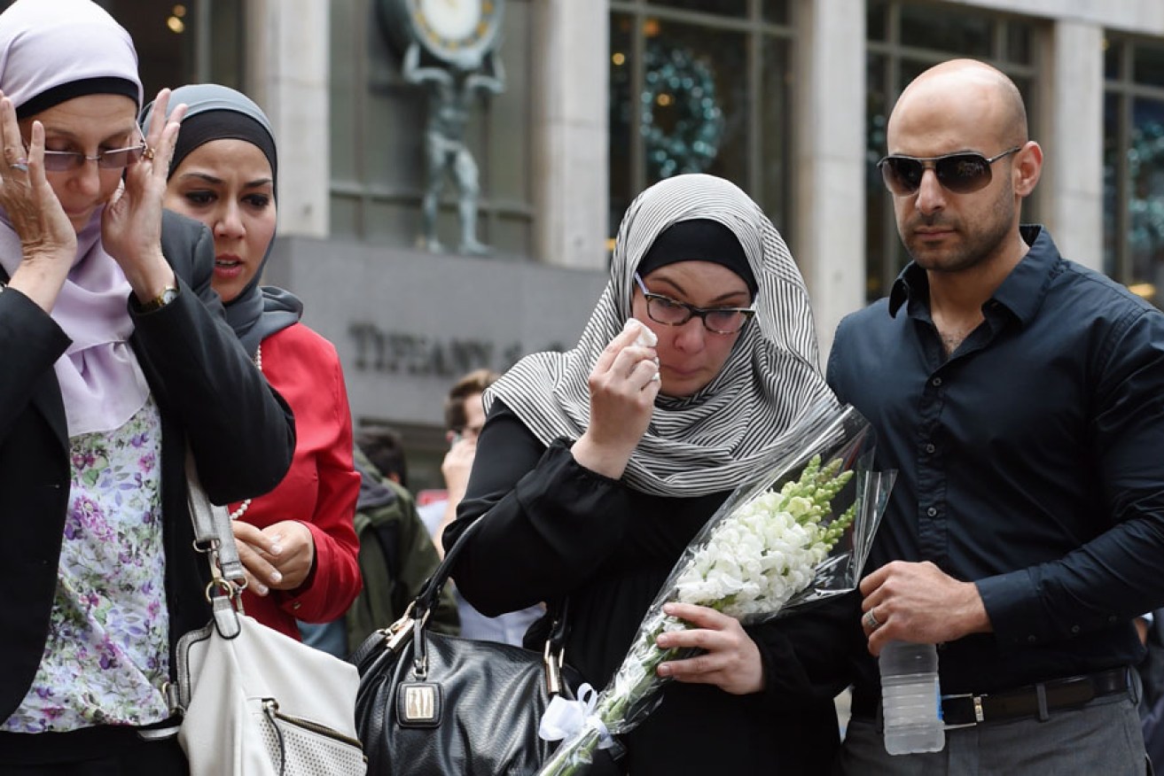 Members of the Muslim community lay flowers in Martin Place.