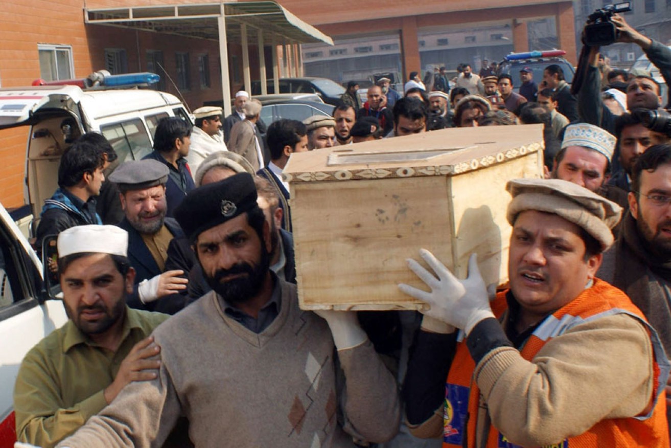 Volunteers carry the coffin of a student killed in a Taliban attack on a school in Peshawar.
