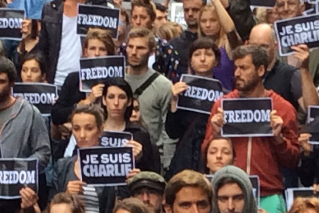 Attendees hold "Je Suis Charlie" signs during a solidarity rally in Martin Place, Sydney.