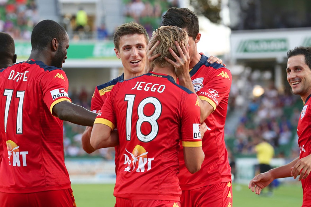 James Jeggo is congratulated by team-mates after scoring the winner against Perth.