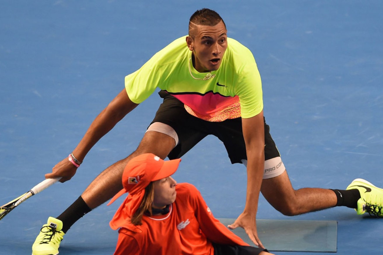 Nick Kyrgios plays a shot around a ballboy during his singles match against Italy's Andreas Seppi.