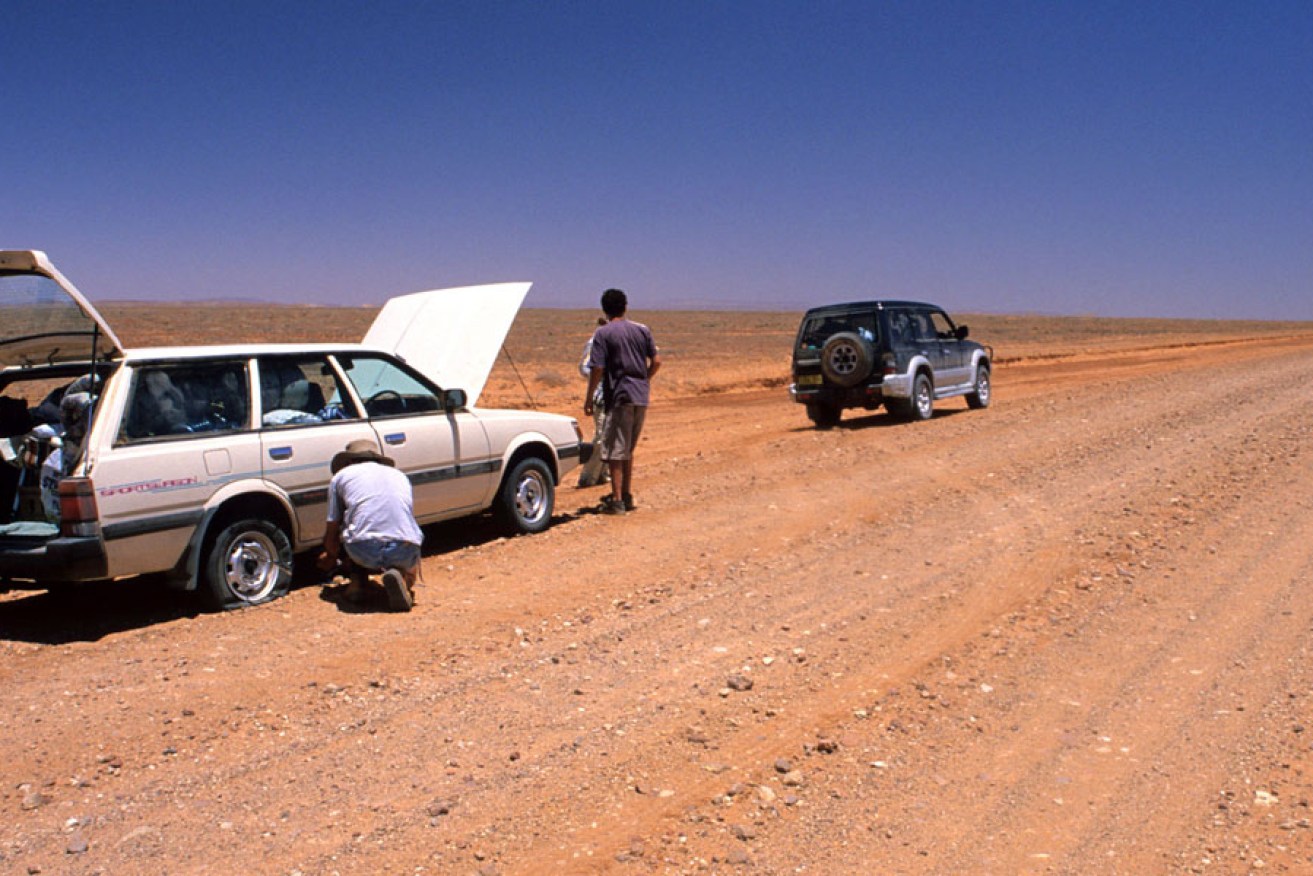 A desert traveller changes a blown tyre near Mount Hopeless on the unforgiving Strzelecki Track. 