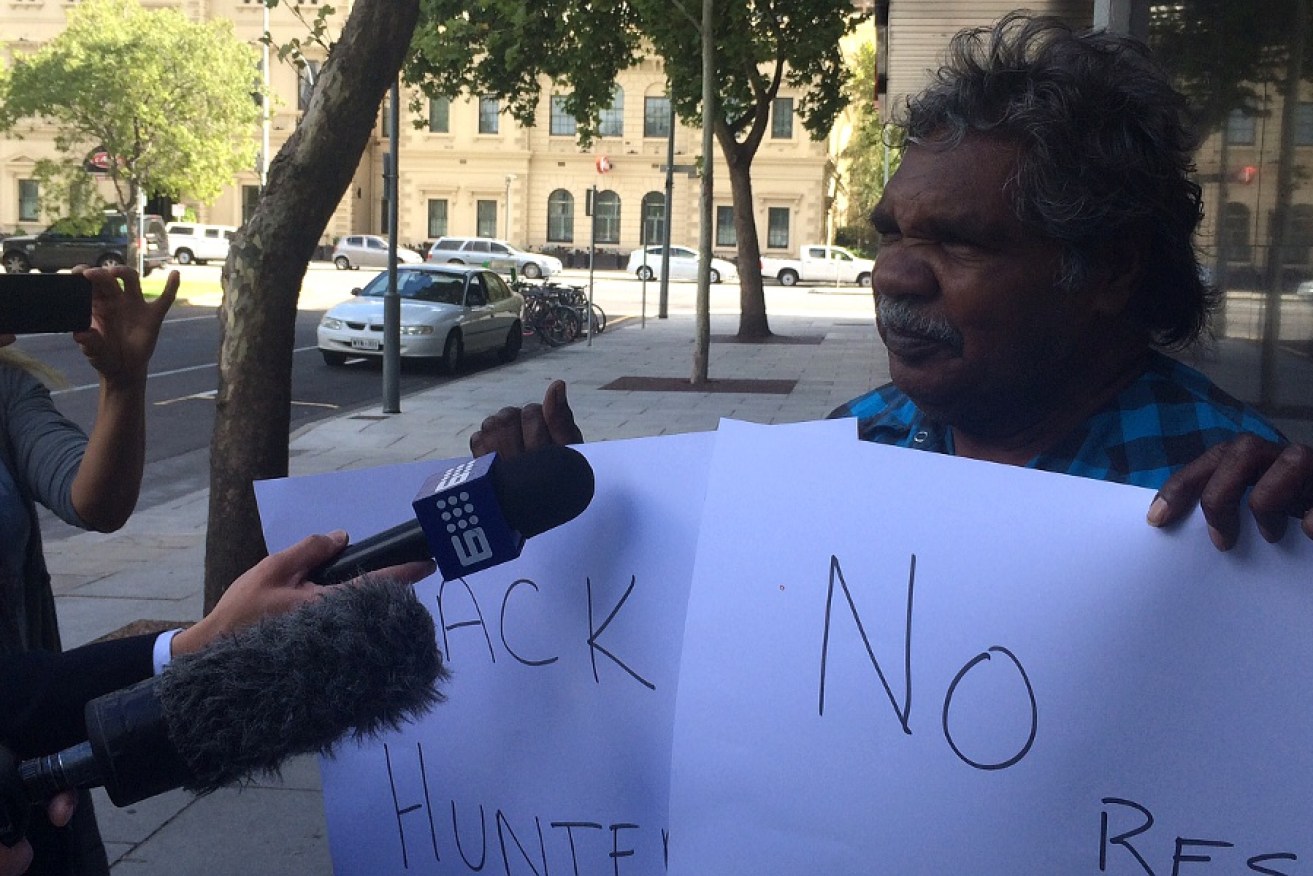 APY Chairperson Owen Burton calls for Ian Hunter to be sacked outside the State Administration building today.