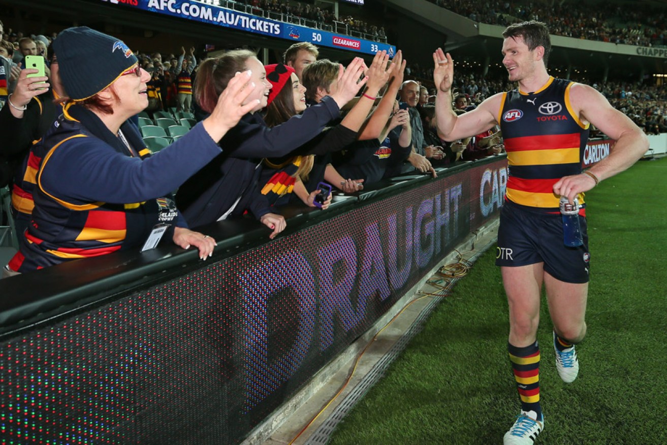 Crow Patrick Dangerfield greets the "19th Man" after Adelaide's Round 9, 2014 win against Collingwood