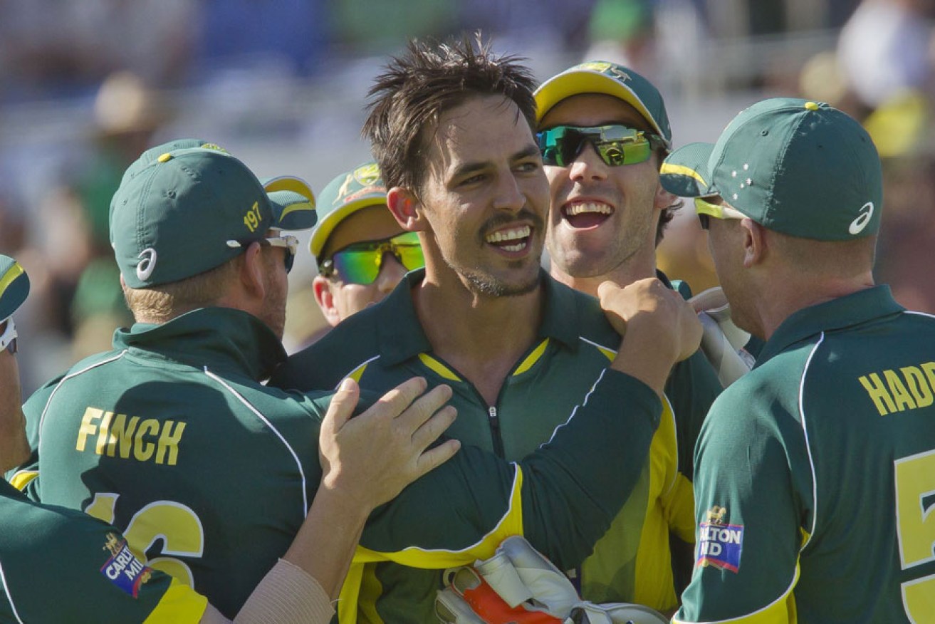 MItchell Johnson is mobbed by teammates after dismissing England captain Eoin Morgan.