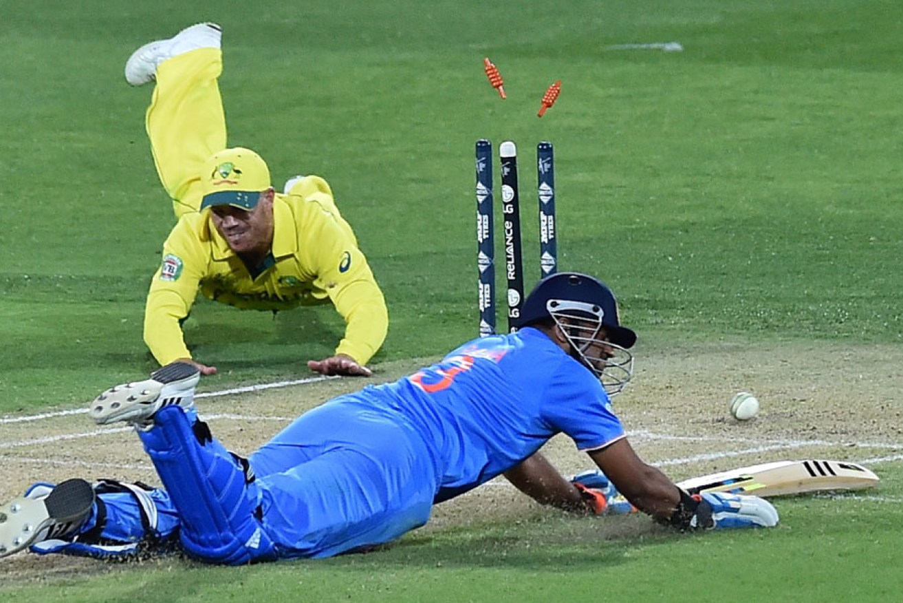 India's Suresh Raina is run out by David Warner during the World Cup warm up match at Adelaide Oval.