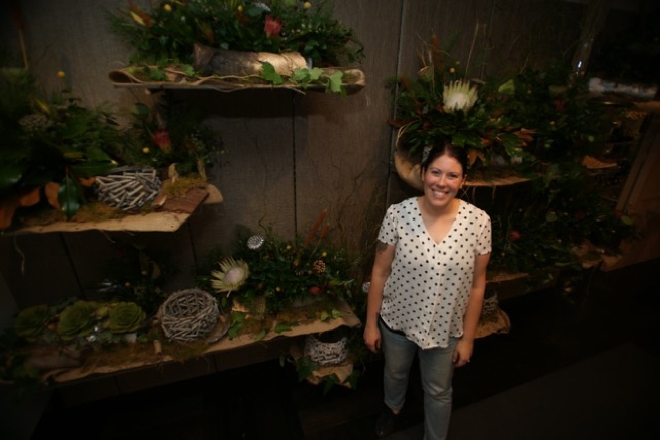 Andrea Christie with her 'wall of flowers' for Mimco VIP event